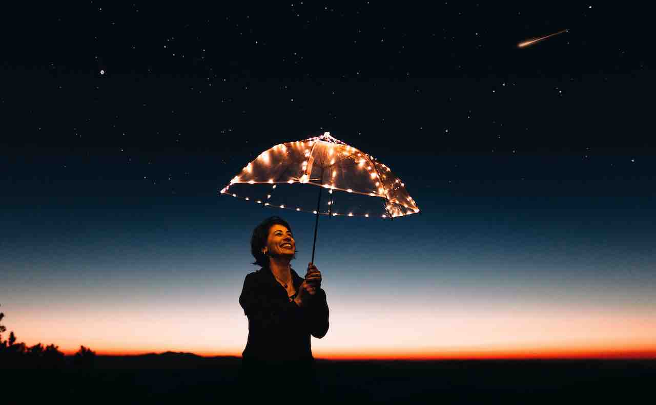 光る傘を持つ女性